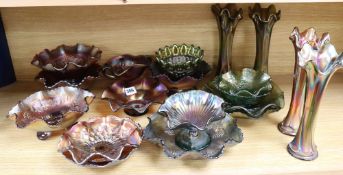 A quantity of mixed green and orange Carnival glass dishes and vases