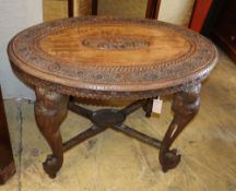 A heavily carved Indian table with elephant carved legs, W.92cm, D.60cm, H.63cm