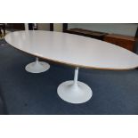 Martino Gamper. An oval white laminate and ply table on two aluminium circular bases, W.250cm, D.