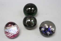 Four glass paperweights