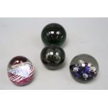 Four glass paperweights