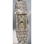 A lady's Art Deco white metal (stamped platinum) and diamond set manual wind cocktail watch, with