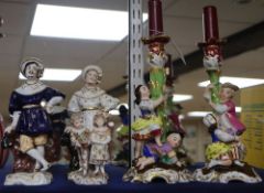 A pair of porcelain candlesticks, a pair of German porcelain figures and a later 19th century