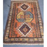 A Caucasian rust ground geometric patterned rug, 172 x 112cm