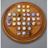 A Victorian mahogany solitaire board and set of marbles