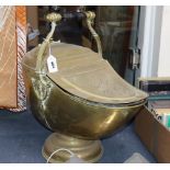 A helmet-shaped brass coal scuttle