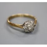 An 18ct, plat and diamond circular cluster ring, size O, gross 2.7 grams.