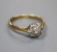 An 18ct, plat and diamond circular cluster ring, size O, gross 2.7 grams.