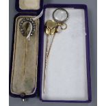 A Victorian yellow and white metal and old cut diamond set horseshoe stick pin, 7cm, two other stick