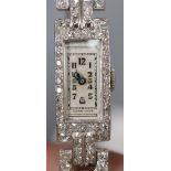 A lady's white metal (stamped platinum) and diamond set cocktail watch, on twin leather strap with