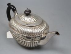 A Victorian fluted silver oval teapot by William Hunter, London, 1886, gross 20.5oz, with engraved