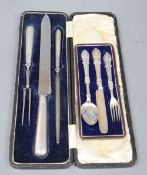 A cased Edwardian silver handled three piece carving set and a cased plated christening trio.