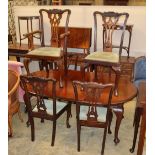 An early 20th century Chippendale revival mahogany dining suite comprising extending dining table