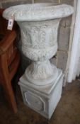 A reconstituted stone campana garden urn on stand, Diameter 40cm, H.88cm