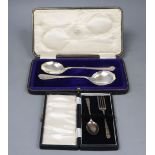 A George V cased pair of silver serving spoons, Sheffield, 1921 and a cased silver christening pair,