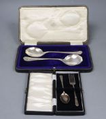 A George V cased pair of silver serving spoons, Sheffield, 1921 and a cased silver christening pair,