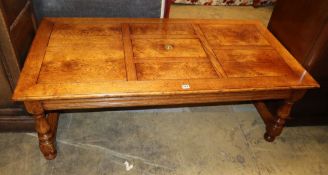 An 18th century style rectangular oak coffee table with central box compartment, W.140cm, D.70cm,
