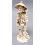 A Japanese sectional walrus ivory figure of a cormorant fisherman, character marks to base, height