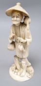 A Japanese sectional walrus ivory figure of a cormorant fisherman, character marks to base, height