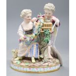 A Meissen figure group of a boy and girl with cage and garland, underglaze blue crossed sword marks,