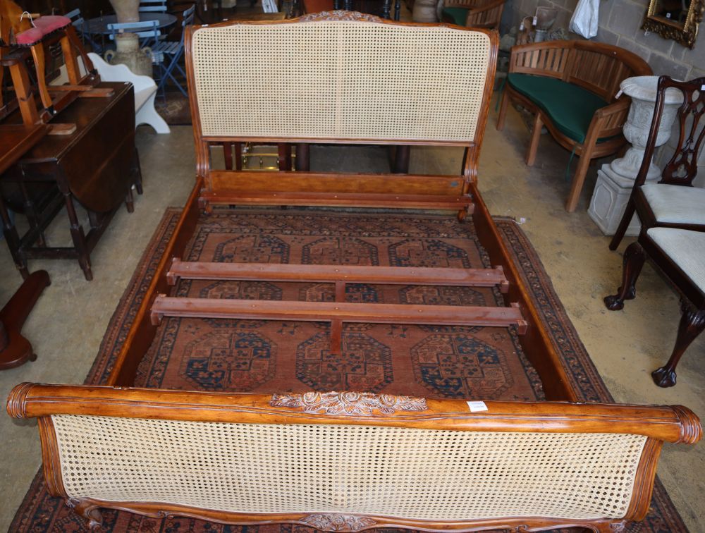 A Louis XV style carved walnut double caned bed frame by Andsotobed, W.160cm, H.120cm