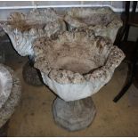 A set of three reconstituted stone campana garden urns, 50cm diameter, H.58cm