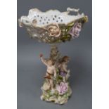 A Sitzendorf floral encrusted porcelain fruit stand, on a figural support, overall height 40cm