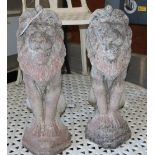 A pair of reconstituted stone lion garden ornaments, H.54cm