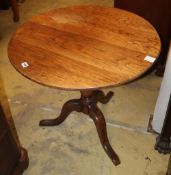 A George III provincial oak tilt top tea table, on three splay legs, 72cm diameter, H.68cm