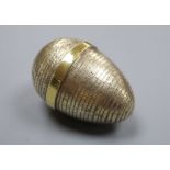 A modern textured silver gilt surprise egg by Stuart Devlin, London, 1985, opening to reveal a