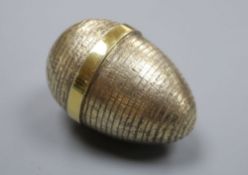 A modern textured silver gilt surprise egg by Stuart Devlin, London, 1985, opening to reveal a