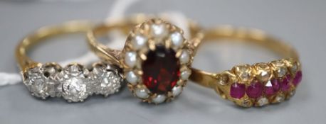 Two 18ct and gem set rings including a three stone diamond ring and a ruby and diamond ring, gross