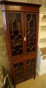 An Edwardian Sheraton revival mahogany and satinwood crossbanded corner display cabinet, on cabriole