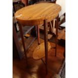 A Sheraton style painted satinwood oval two tier table, W.52cm, D.36cm, H.72cm