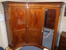 An unusual Sheraton revival fiddle back mahogany corner triple wardrobe, W.280cm, maximum depth