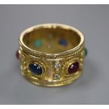 A modern yellow metal, diamond and cabochon ruby, sapphire and emerald set band, signed 'Alex', size