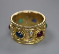 A modern yellow metal, diamond and cabochon ruby, sapphire and emerald set band, signed 'Alex', size