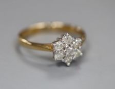 A modern 9ct gold and diamond cluster flower head ring, size J, gross 1.6 grams.