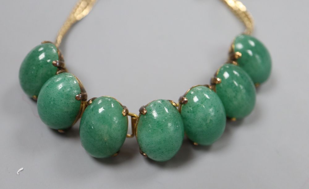 A 14k yellow metal and simulated cabochon jade set bracelet, 18.3cm, gross 33.4 grams.