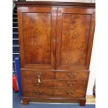 A George III mahogany linen press, oval panels, W.134cm, D.59cm, H.200cm