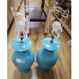 A pair of turquoise glazed baluster table lamps, with pleated cream shades, height 49cm