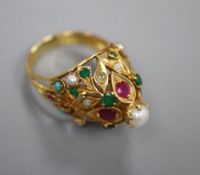 A modern yellow metal and multi gem set cocktail ring, size O/P, gross 11.5 grams.CONDITION: