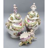 A pair of Augustus Rex floral encrusted porcelain vases and covers and a similar putti