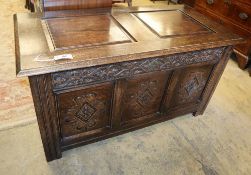 An 18th century-style panelled oak coffer, W.122cm, D.60cm, H.64cm