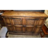 An 18th century style linen fold moulded oak two door cabinet, W.150cm, D.39cm, H.107cm