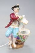 A late Meissen figural salt, modelled as a seated gallant and companion beside a floral encrusted