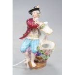 A late Meissen figural salt, modelled as a seated gallant and companion beside a floral encrusted