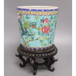 A Chinese turquoise glazed 'dragon' jardiniere and wood stand, overall 33cm