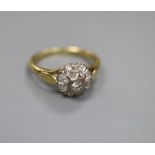 A modern 18ct gold and illusion set diamond cluster ring, size J, gross 3.4 grams.