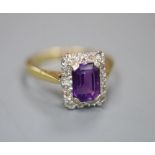 An 18ct, amethyst and diamond chip set rectangular cluster ring, size M, gross 3.3 grams.